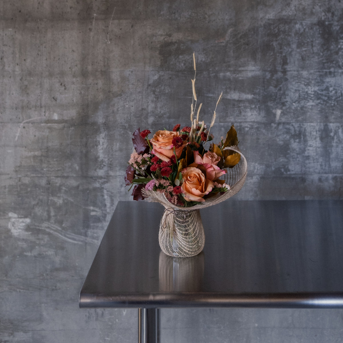 SmallThanksgiving flower arrangement with seasonal fall blooms in a vase Boise Idaho. 